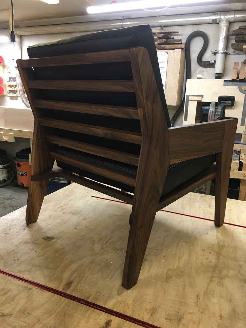 Solid walnut armchair with black cushions.  Back view . 