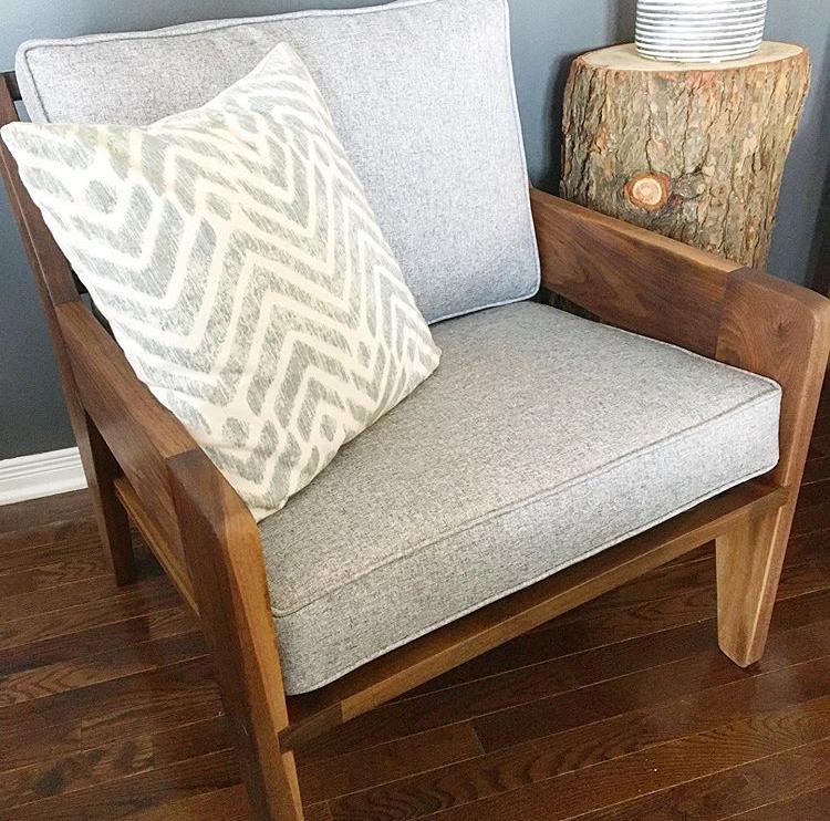 Solid walnut armchair with grey tweed cushions.   