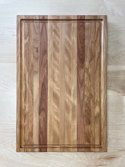 Solid birch cutting board with drip edge. Top view.