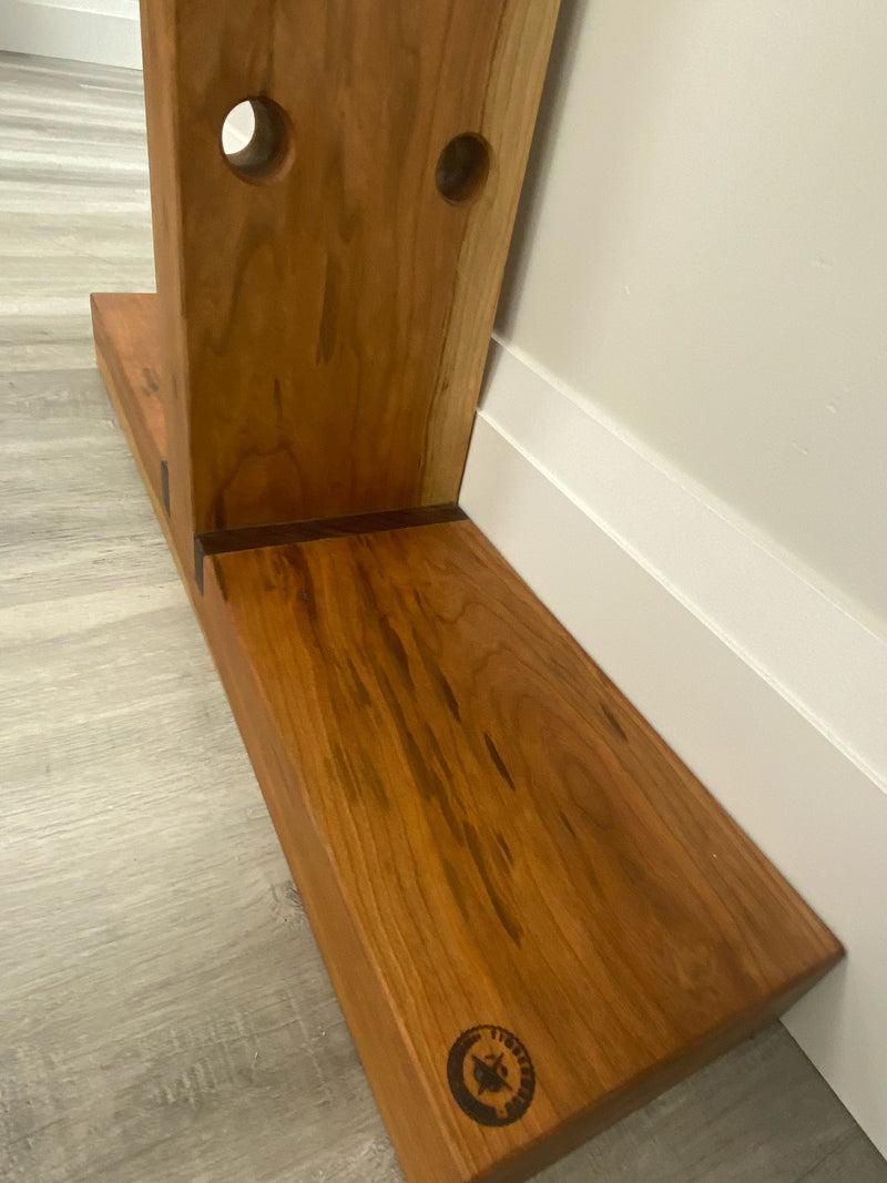 Solid black cherry vertical wine rack with walnut accents. Base close up view.