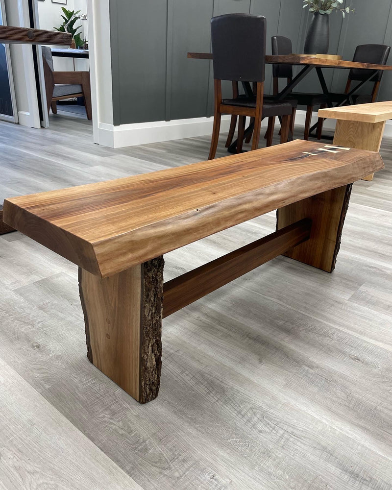 Solid black walnut bench with a live edge and maple bowties. Side view.