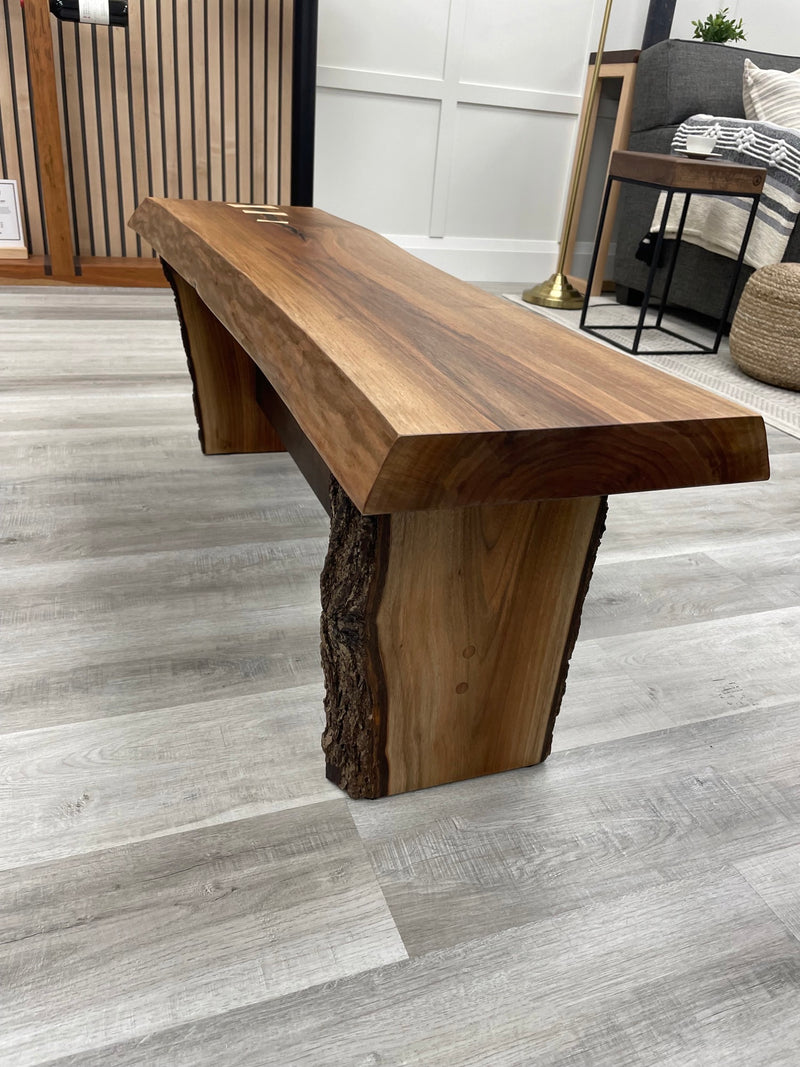 Solid black walnut bench with a live edge and maple bowties. Side view.