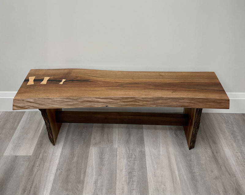 Solid black walnut bench with a live edge and maple bowties 