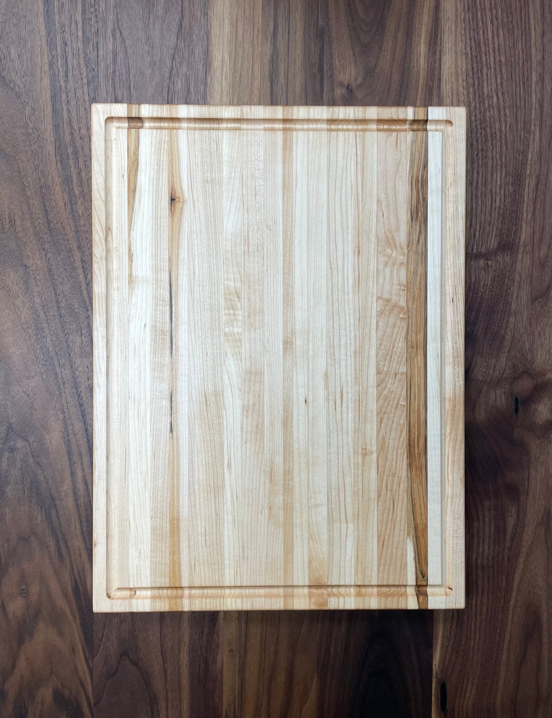  Solid maple cutting board with drip edge. Top view.
