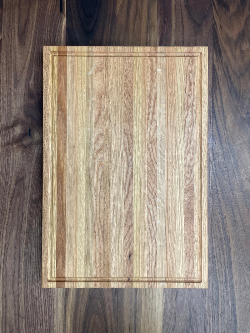 Solid oak cutting board with drip edge. Top view.