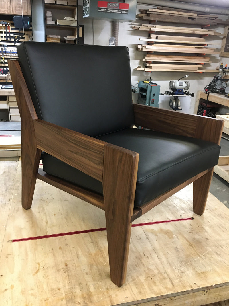 Solid walnut armchair black cushions.  