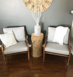 A pair of solid walnut armchairs with grey tweed cushions.  Shown with a decorative throw and an accent pillow.  