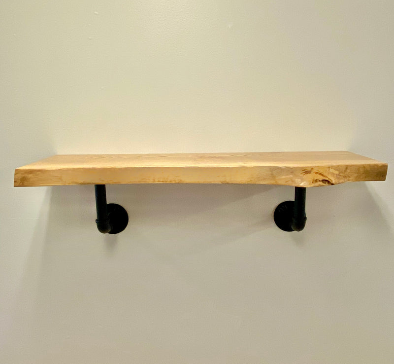 Natural edge, solid wood shelf with black pipe brackets