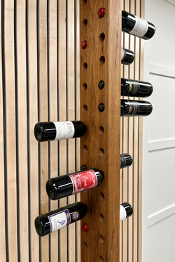 Solid black cherry vertical wine rack with walnut accents. Shown with wine bottles.