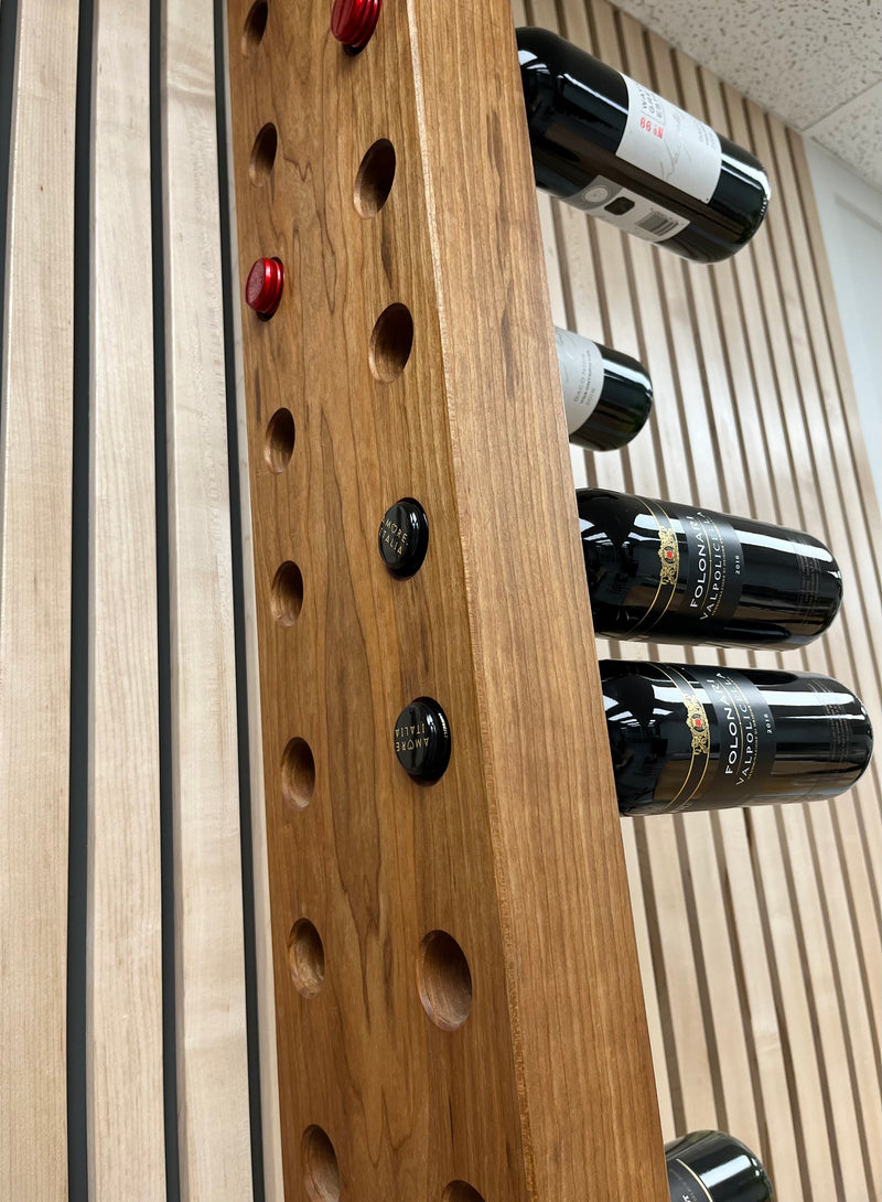 Solid black cherry vertical wine rack with walnut accents. Close up view.