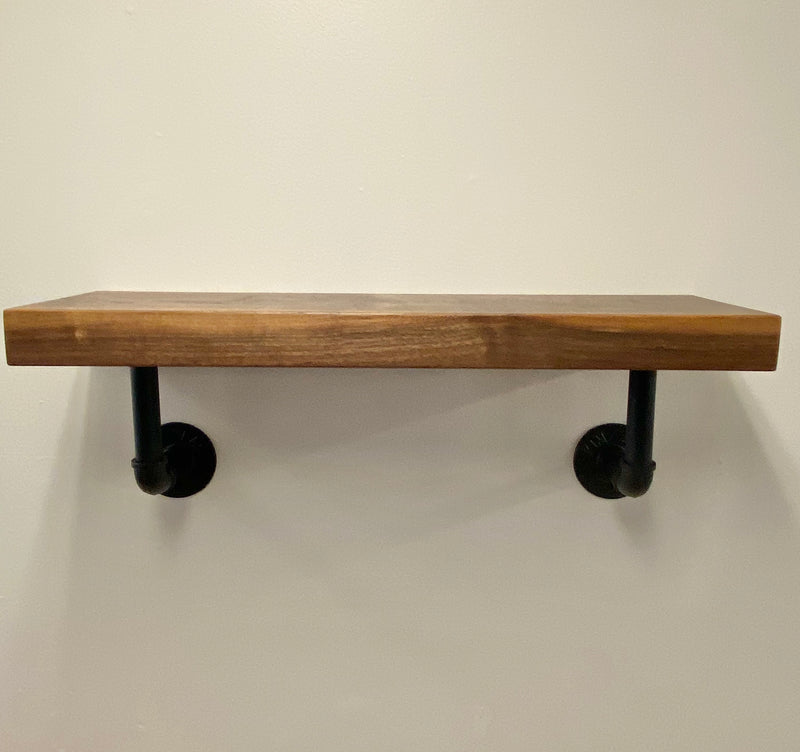 solid wood shelf with black pipe brackets